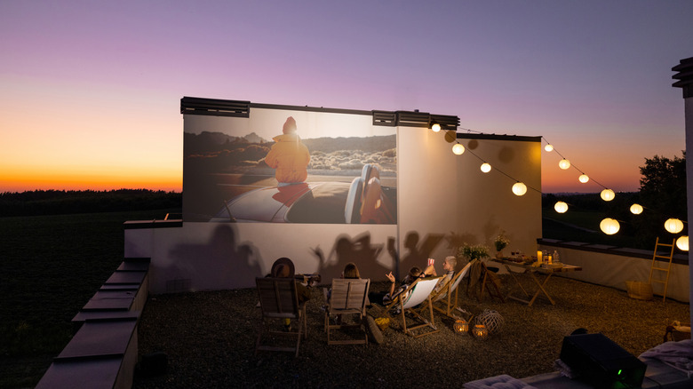 Projecting a movie onto a wall for an outdoor movie night