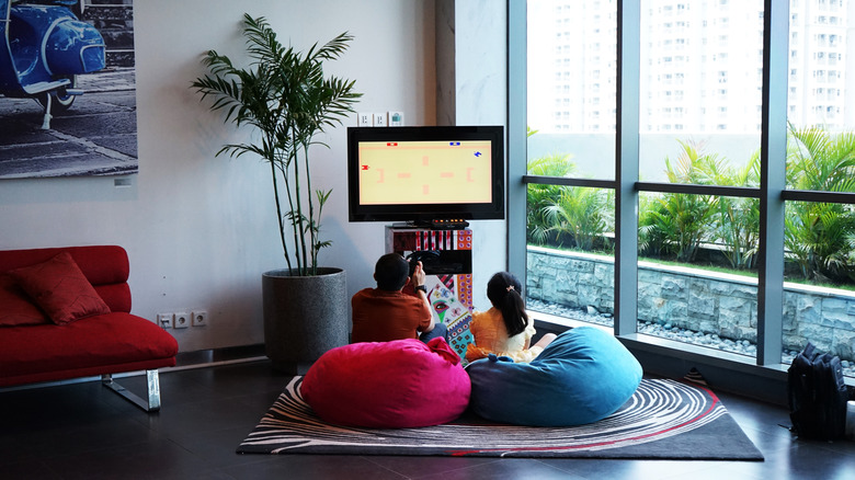 Kids playing a video game in bean bag chairs