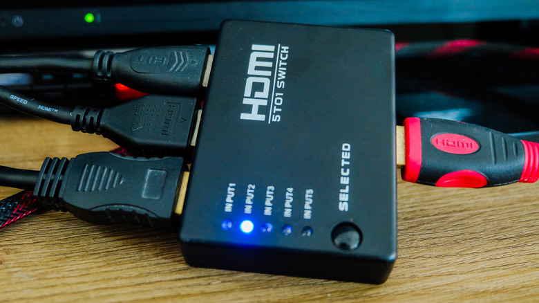 An HDMI switch with several cables plugged in.