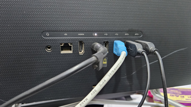 A computer monitor with an open HDMI port on the back.