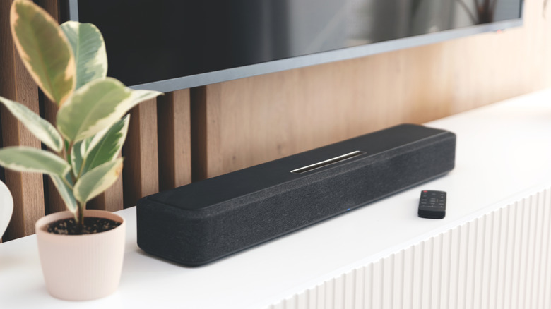 A soundbar underneath a living room TV.