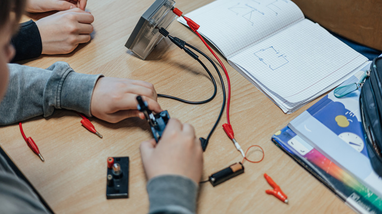 Children assembling an electric circuit in a classroom setting