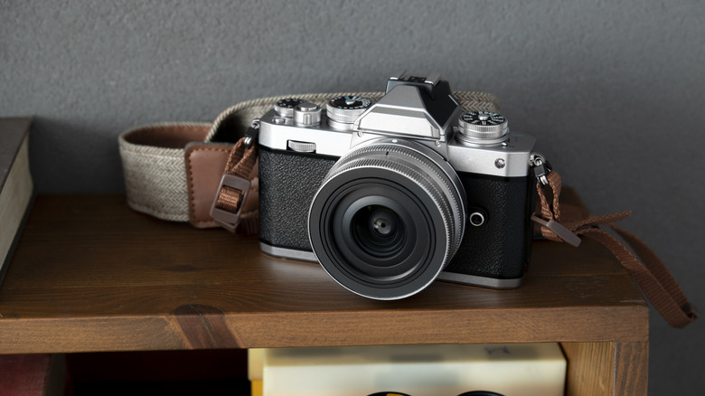 An old camera on display on an end table
