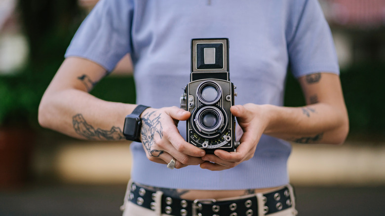 An old camera being held for a photo