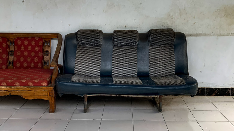 An old bucket seat from a car used as a couch.