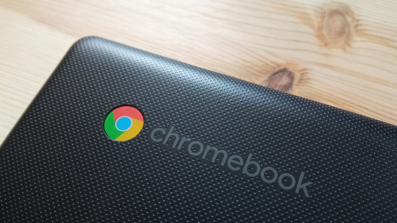 laptop with a Chromebook logo placed on a wooden desk