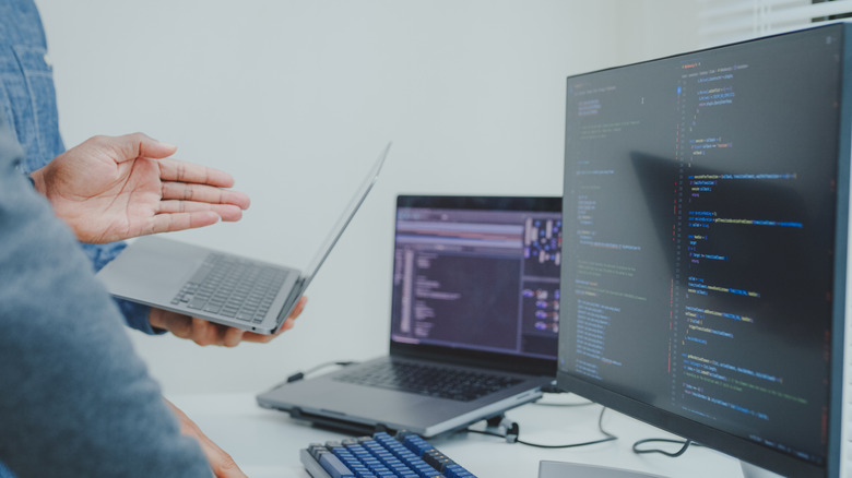 laptop and monitor placed on a workstation