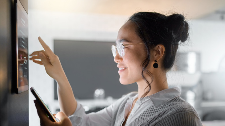 A woman using smart home dashboard