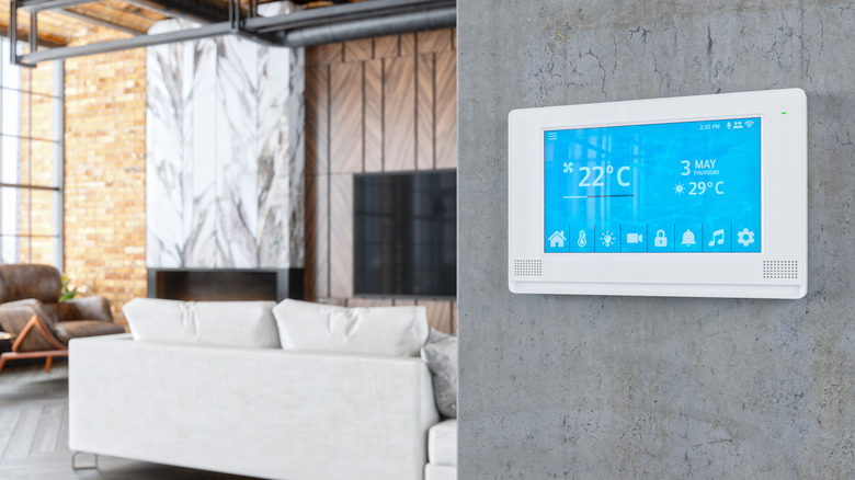 Wall-mounted smart hub displaying temperature
