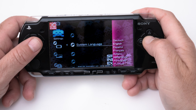 A PSP held in hand, browsing settings