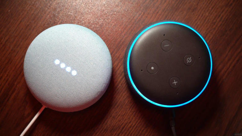 Google Home Mini and Amazon Echo Dot side by side on a wooden surface.