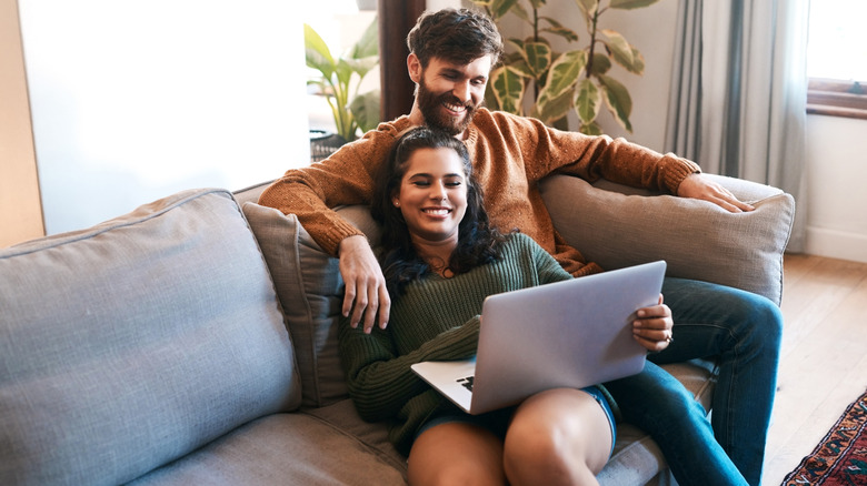 couple streaming content on laptop