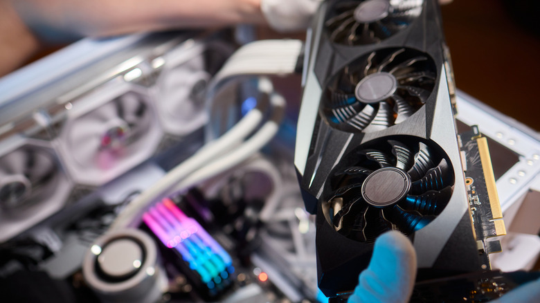 a gpu with a PC in the background