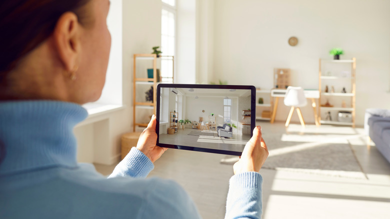 Woman holding a tablet with an image displayed
