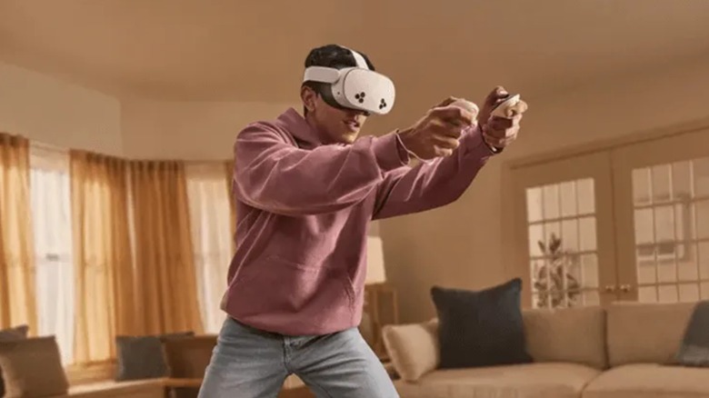 Person in a living room playing a VR game with a Meta Quest 3S