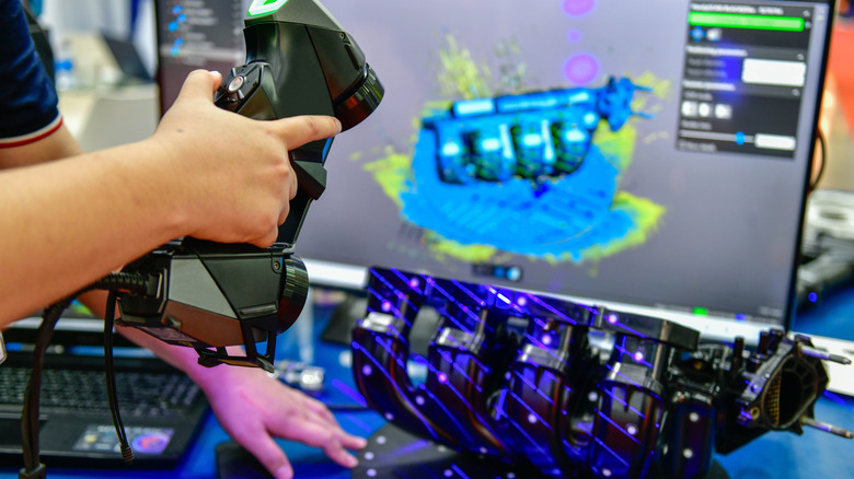 A person using a 3D scanner to scan an object