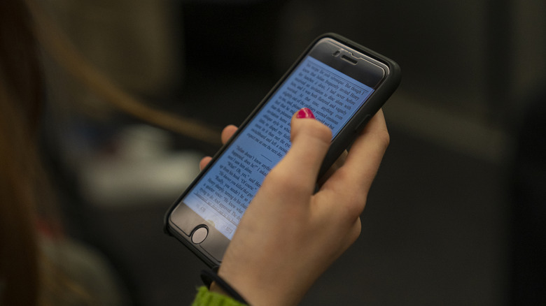 Person reading an ebook on their smartphone