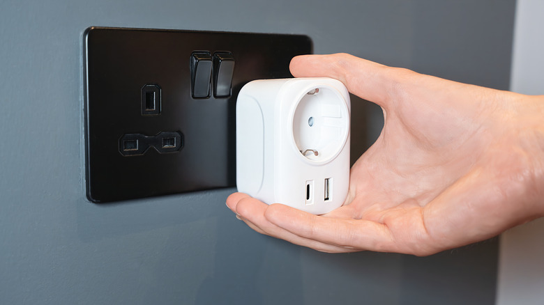 smart plug with usb ports plugged into a socket