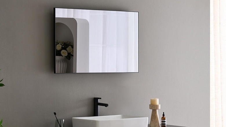 An Elecsung Smart Mirror TV above a sink.