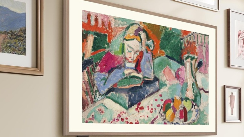 A Hisense frame TV in Art Mode surrounded by artwork.