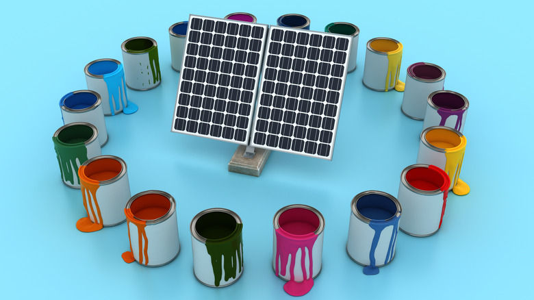 A solar panel surrounded by pots of different-colored paint.