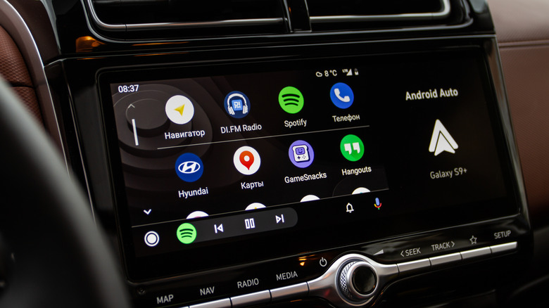 A vehicle's infotainment display showing Android Auto, there are two rows of icons featuring various apps
