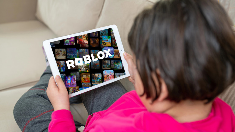 AKid loading up Roblox on a tablet