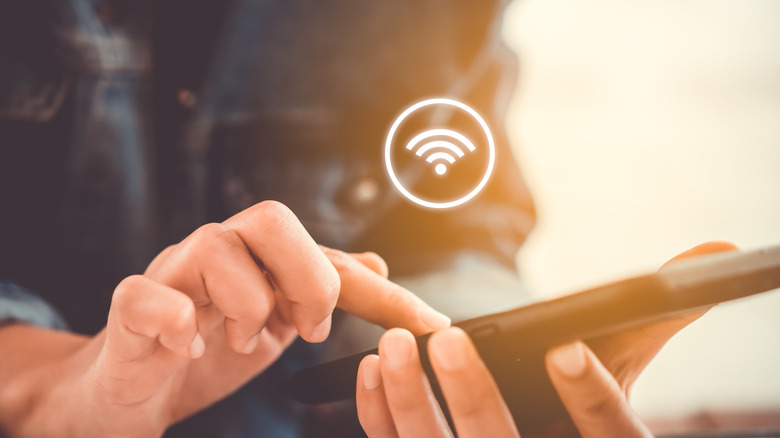 Woman using wifi button on parental controls via her smartphone