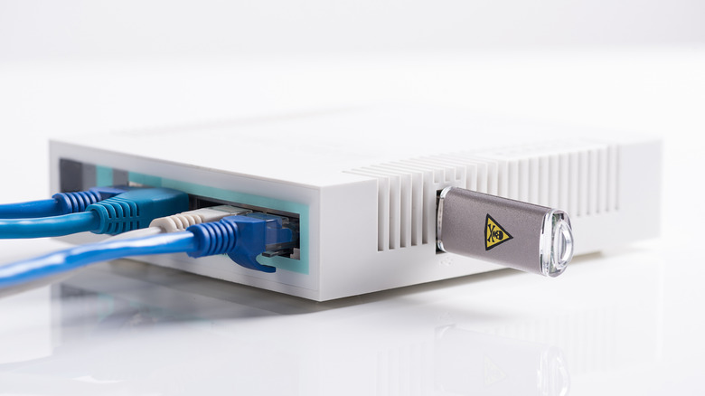 white router with wires and a flash drive