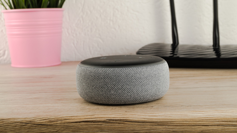 Compact smart speaker on a wooden desk.