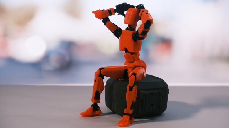 3D printed dummy with arms raised in frustration