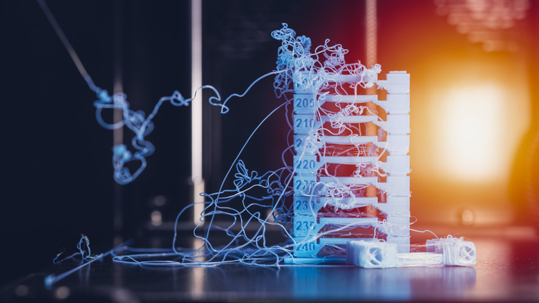 3D printer with an extruder error causing the filament to string out of control