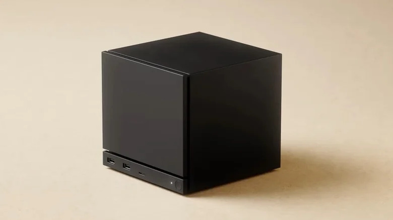 A black Steam Machine mini-PC from Valve sits in the middle of a beige backdrop