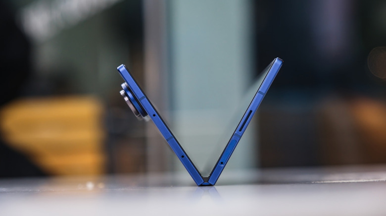 A Samsung Galaxy Z Fold7 in a V shape on a blurred surface