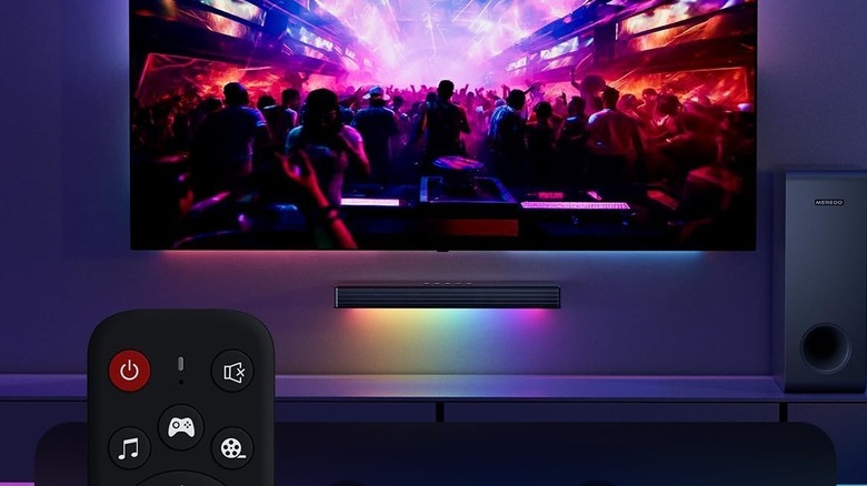 A Meredo soundbar with RGB lighting mounted below a wall-mounted TV.