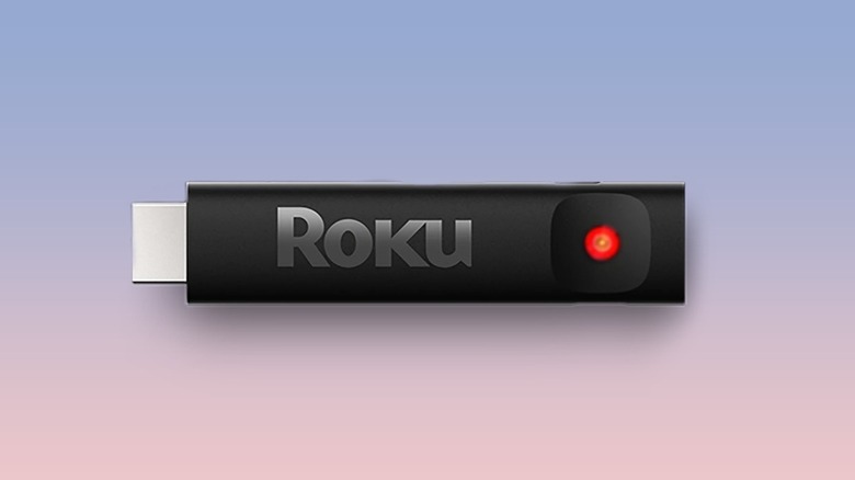 A Roku streaming stick with a turned on red light