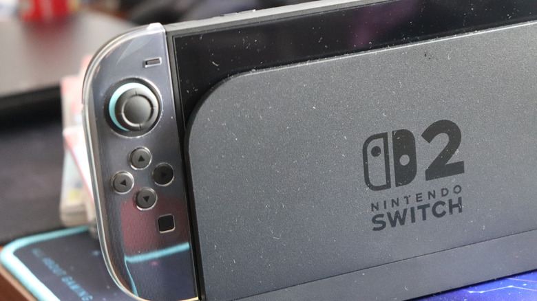 A closeup of a Nintendo Switch 2 console sitting in its black dock, the Nintendo Switch 2 logo is prominent on the dock