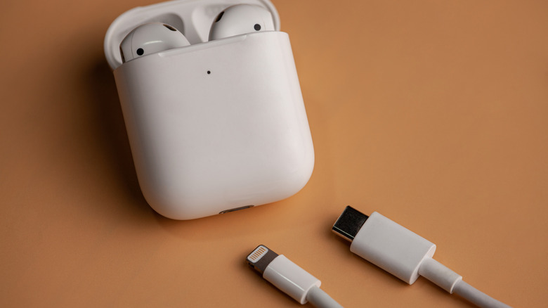 AirPods in the open case with Lightning and USB-C cable