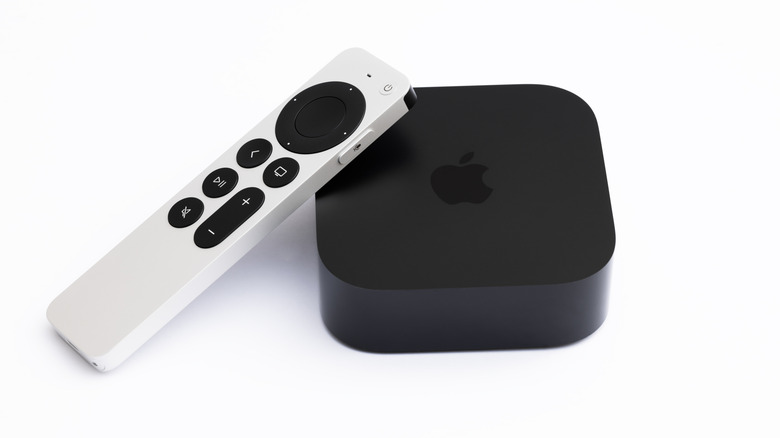 apple tv 4k (3rd generation) placed alonsgide its remote against a white background