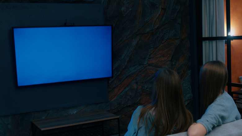 Women looking at TV screen with blue tint