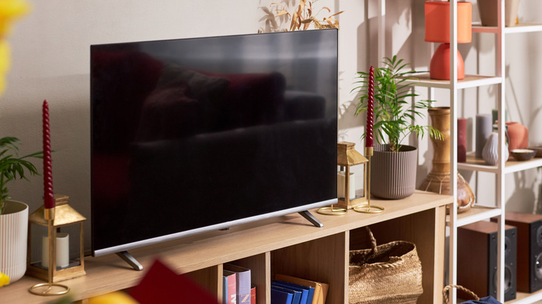 A TV on a wooden stand in a living room