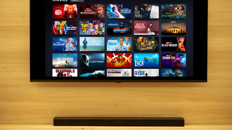 disney+ app running on an TV mounted on the wall with a soundbar placed underneath