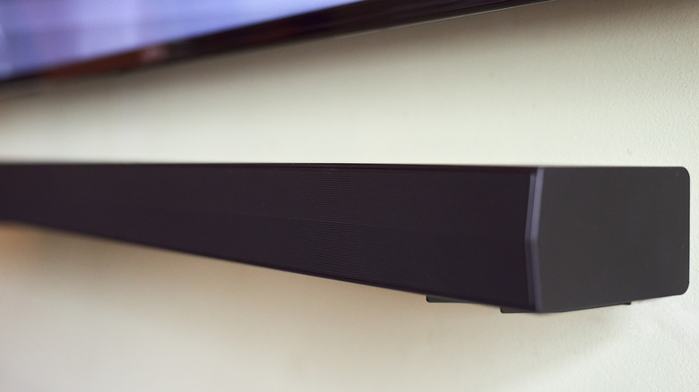 soundbar mounted on a wall underneath a smart TV