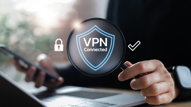 VPN shield graphics with lock and check mark on the side and a person with a smartphone and laptop in the background