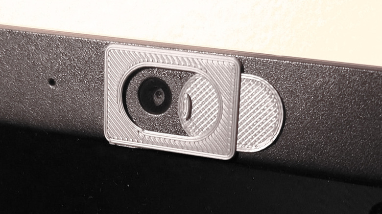3D printed manual webcam cover on the front of a laptop webcam