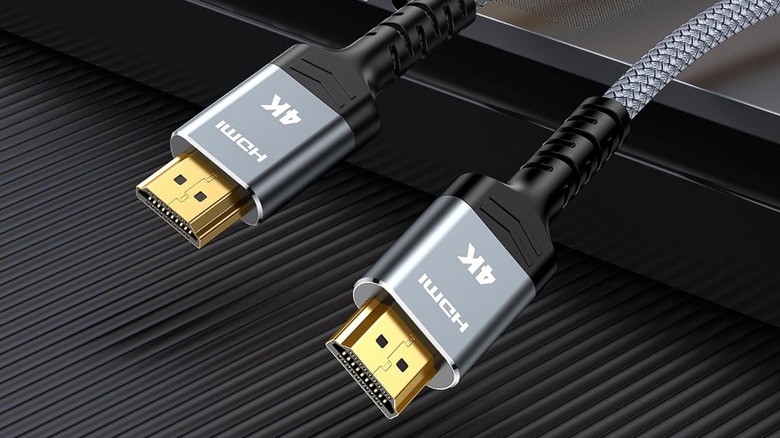 both ends of a Highwings 6.6-foot 4K HDMI Cable hanging off a metal surface