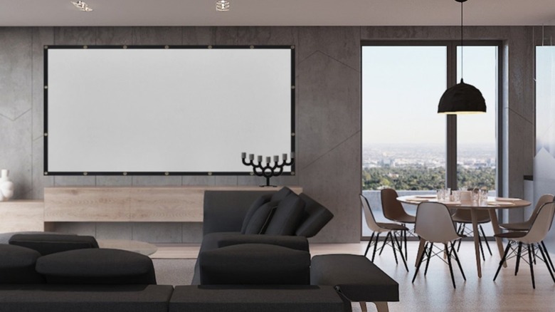 A Mdbebbron 120-inch Projector Screen hangs on a wall in a modern living room