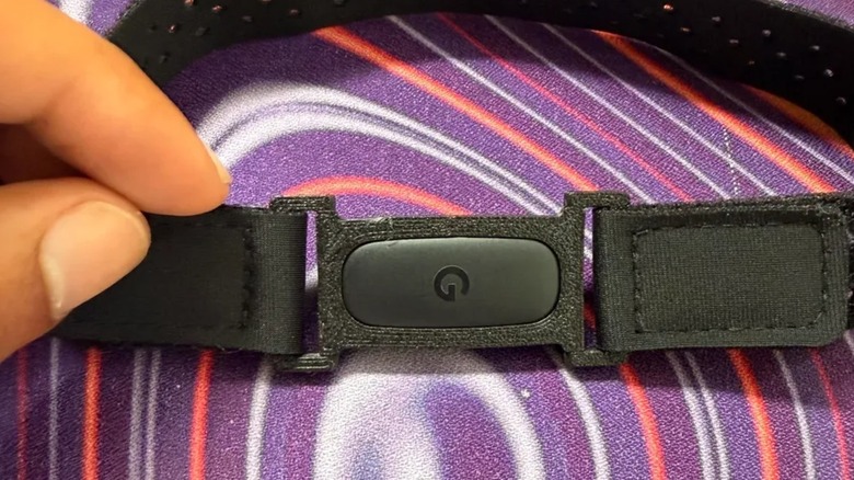 A Fitbit Air in a 3D-printed mount on an elastic bicep strap.