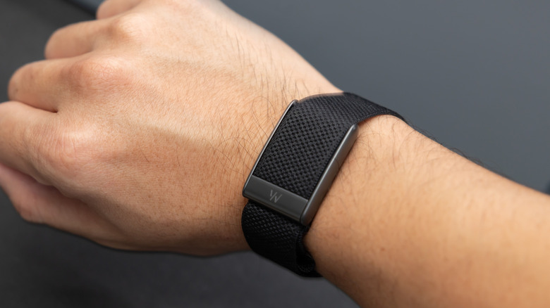 A Whoop fitness tracker on a man's wrist