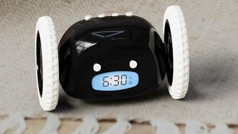 The CLOCKY Alarm Clock on Wheels being used in a bedroom setting.